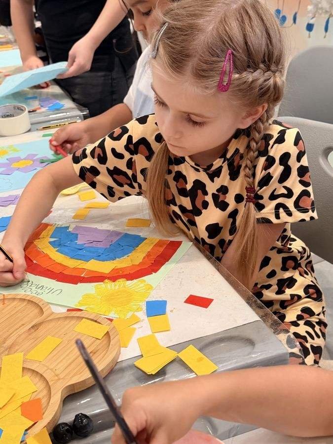 A girl making a paper mosaic