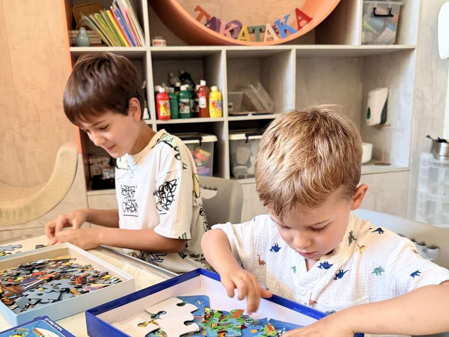 Two boys solving a puzzle