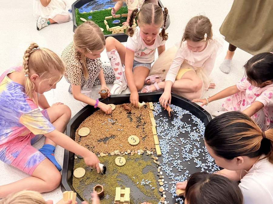 Children around a sensory tray