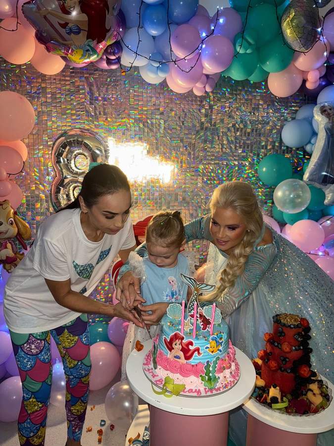 Mom and daughter with the birthday cake